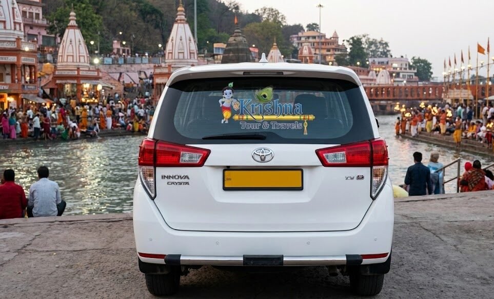 a shri krishna tour and travels taxi parked near the ganges at har ki pauri in haridwar, with the evening aarti preparation visible in the background.