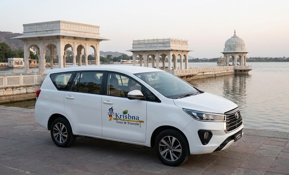 From NCR to the Blue City: Top Taxi Service in Noida for Your Rajasthan Trip a white toyota innova crysta from shri krishna tour & travels is parked at the edge of ana sagar lake in ajmer, with marble pavilions in the background.