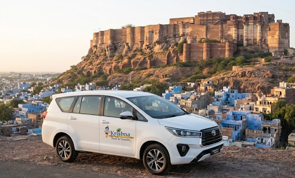 a white toyota innova crysta from shri krishna tour & travels parked on a hill overlooking the blue city of jodhpur, with mehrangarh fort in the background.